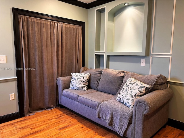 living room with light hardwood / wood-style floors and ornamental molding