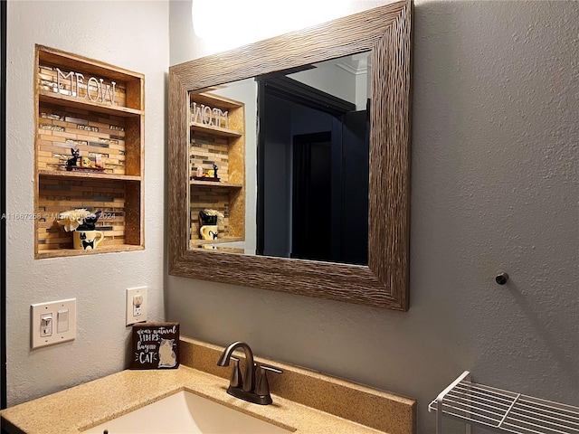 bathroom featuring crown molding and vanity