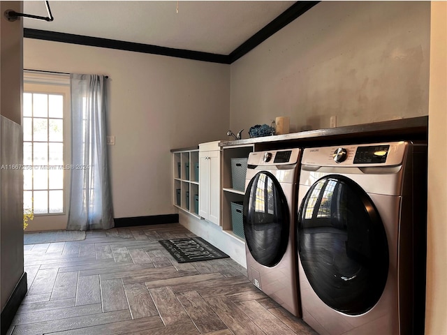 laundry room with parquet flooring, ornamental molding, and washing machine and clothes dryer