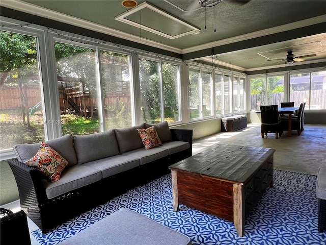 sunroom featuring ceiling fan