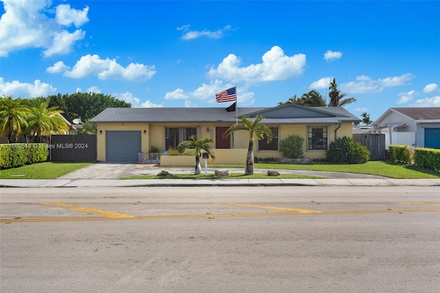 ranch-style home with a front yard and a garage