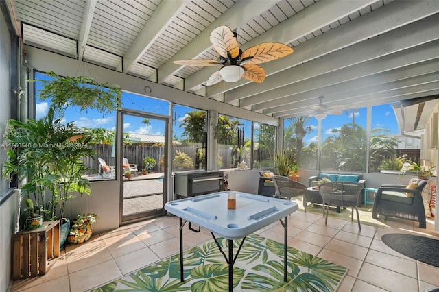 sunroom with beam ceiling and ceiling fan