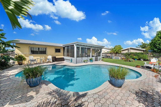 view of swimming pool featuring a sunroom and a patio