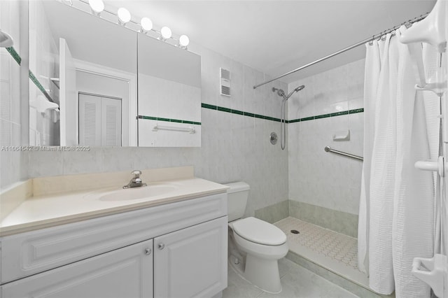 bathroom featuring tile patterned floors, vanity, toilet, and walk in shower