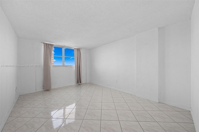 spare room with a textured ceiling