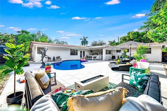 view of pool featuring outdoor lounge area and a patio