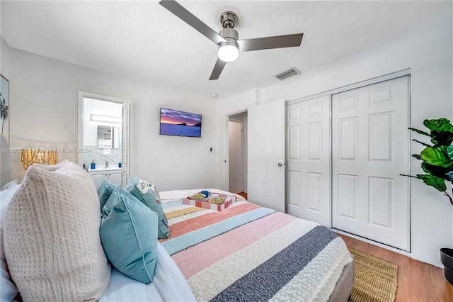 bedroom featuring hardwood / wood-style floors, a closet, and ceiling fan