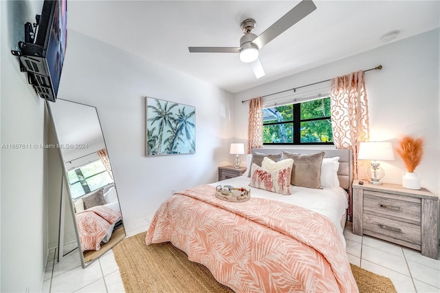 tiled bedroom featuring ceiling fan