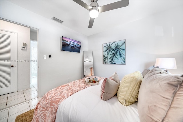 bedroom with ceiling fan and light tile patterned flooring