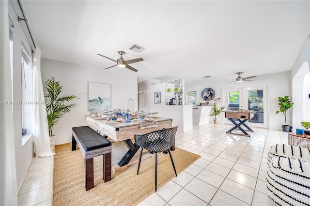 tiled dining area with ceiling fan and french doors