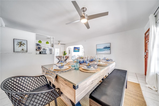 tiled dining area featuring ceiling fan