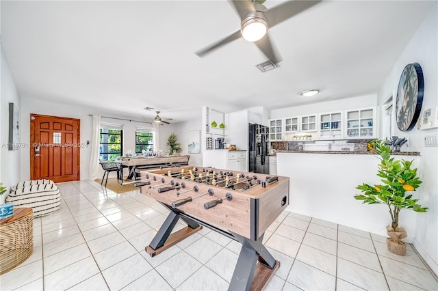 rec room featuring ceiling fan and light tile patterned floors