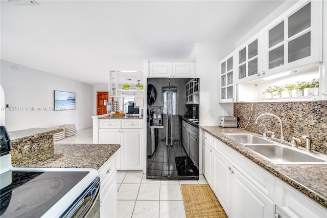 kitchen featuring white cabinets, black appliances, sink, and tasteful backsplash