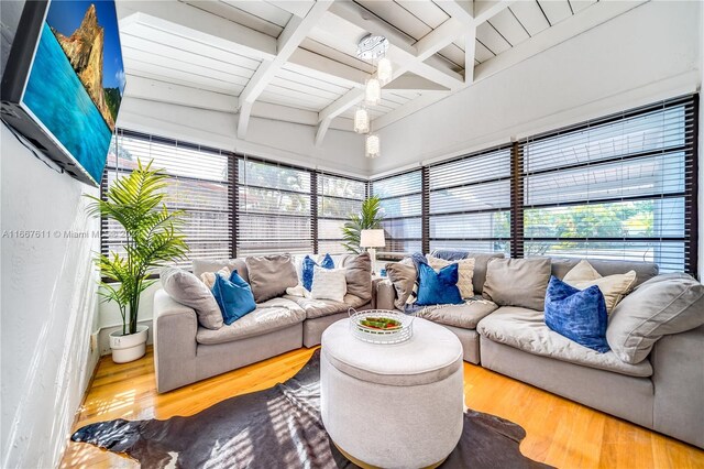 living room featuring beamed ceiling, wood-type flooring, and wooden ceiling