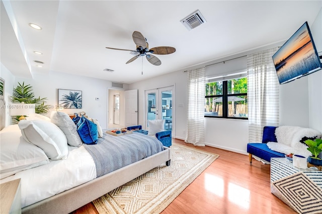 bedroom with ceiling fan and light hardwood / wood-style floors