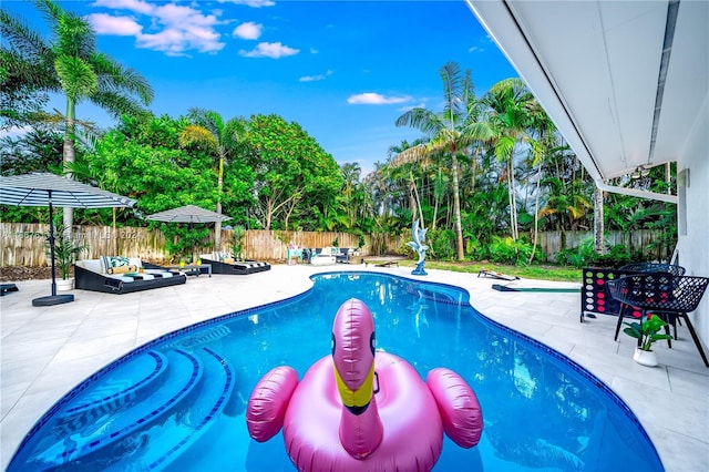 view of pool featuring outdoor lounge area and a patio