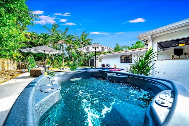 view of swimming pool with a jacuzzi