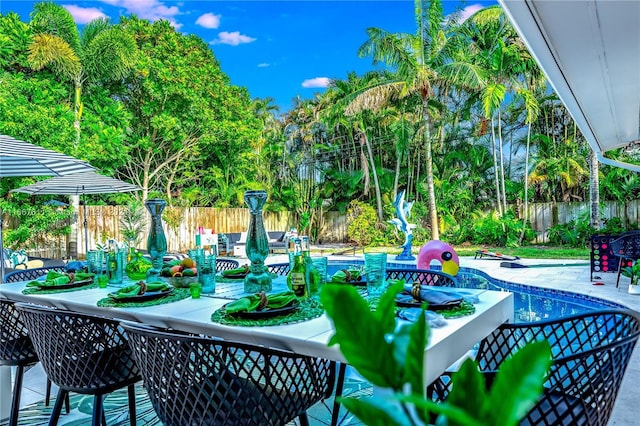 surrounding community featuring a pool and a patio area