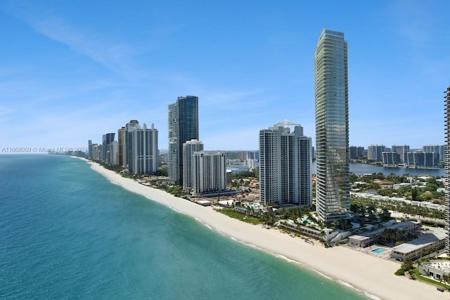 birds eye view of property with a view of the beach and a water view