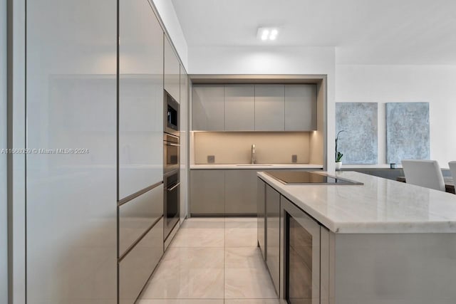 kitchen with wine cooler, gray cabinets, appliances with stainless steel finishes, and sink