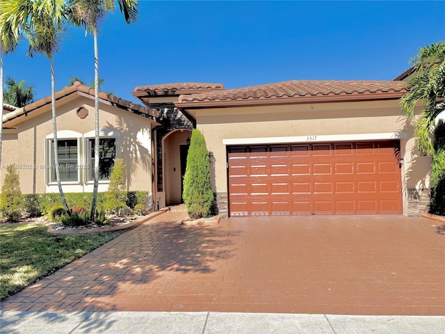 mediterranean / spanish-style house with a garage