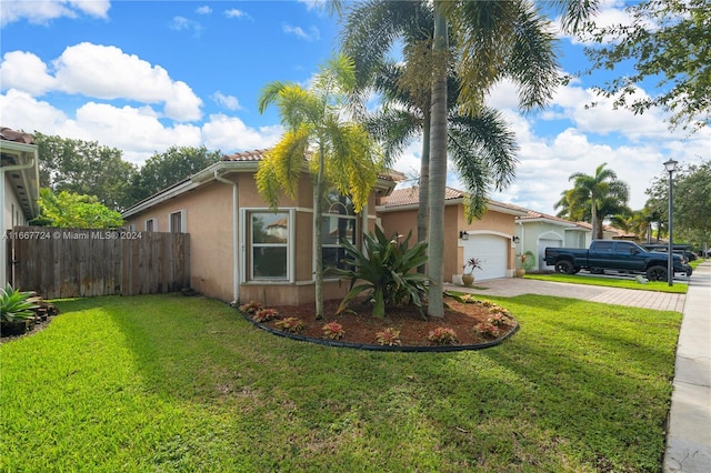 view of front of home featuring a front lawn and a garage