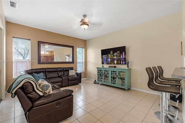 tiled living room with ceiling fan