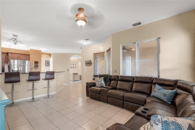 tiled living room with ceiling fan