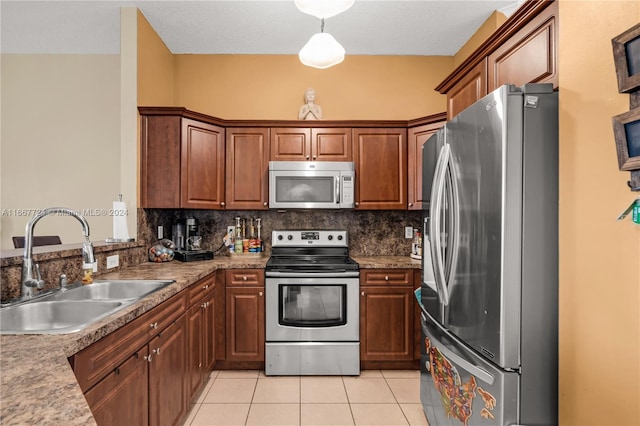 kitchen featuring light tile patterned flooring, sink, tasteful backsplash, appliances with stainless steel finishes, and light stone countertops