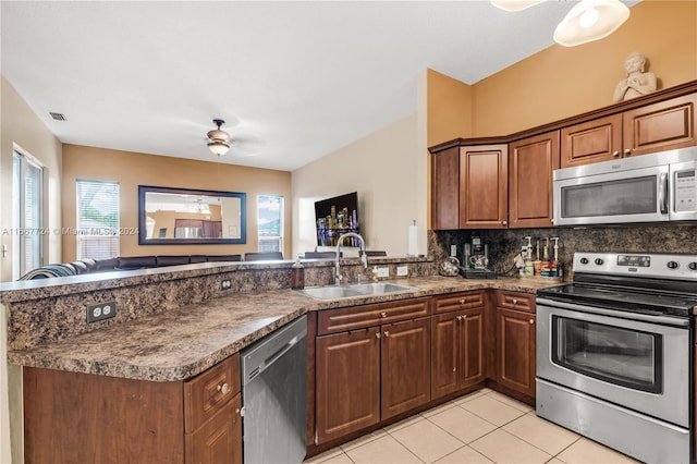 kitchen featuring ceiling fan, appliances with stainless steel finishes, kitchen peninsula, and a wealth of natural light