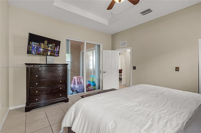 tiled bedroom featuring ceiling fan and a textured ceiling