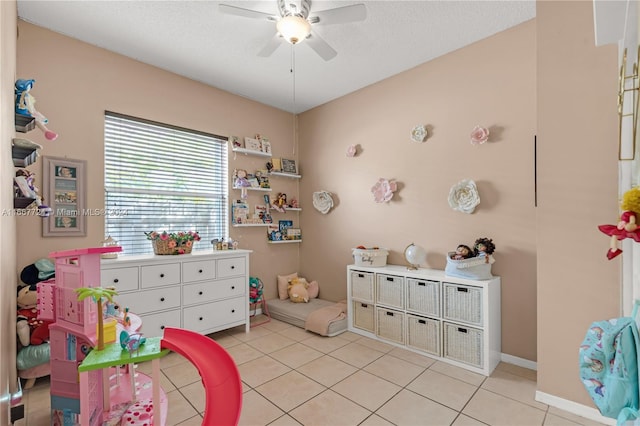 tiled bedroom with ceiling fan and a textured ceiling