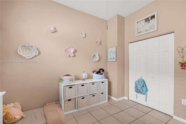 bedroom featuring a closet and light tile patterned floors