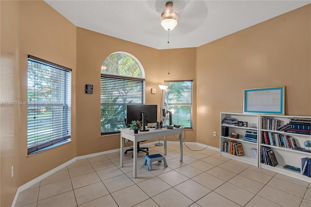 office space with ceiling fan, light tile patterned floors, and a textured ceiling