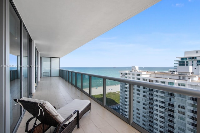 balcony with a water view and a beach view