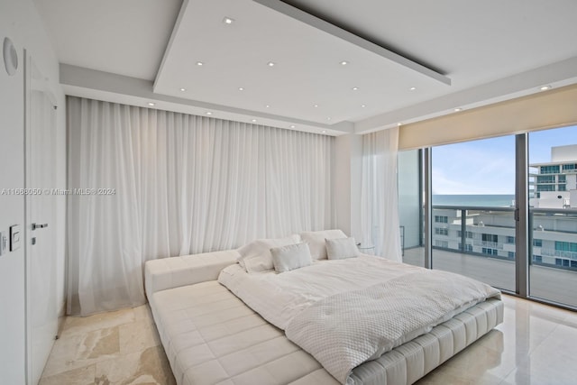 bedroom with access to outside and a water view