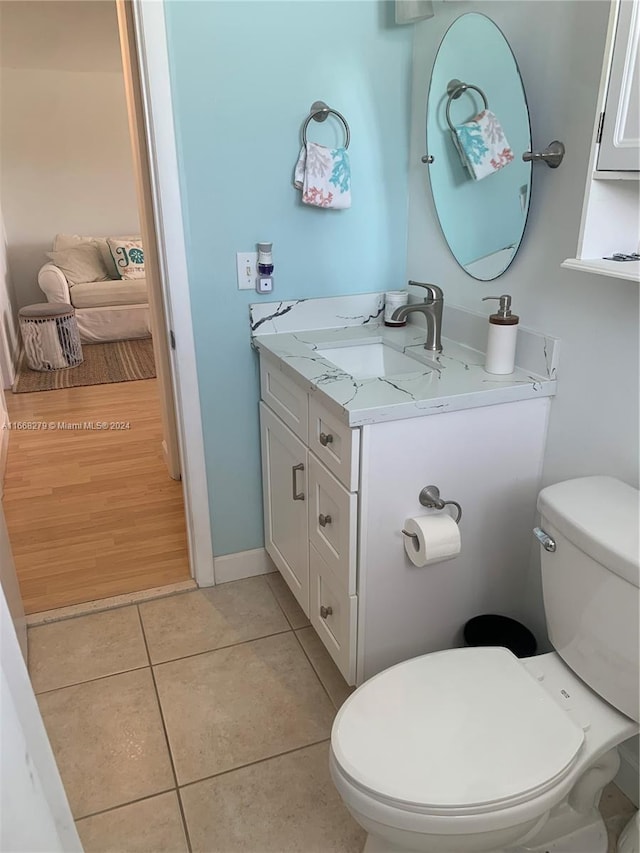 bathroom with tile patterned floors, vanity, and toilet