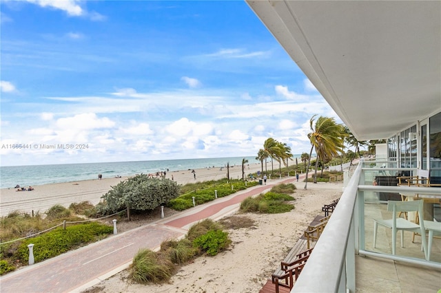 balcony with a water view and a beach view