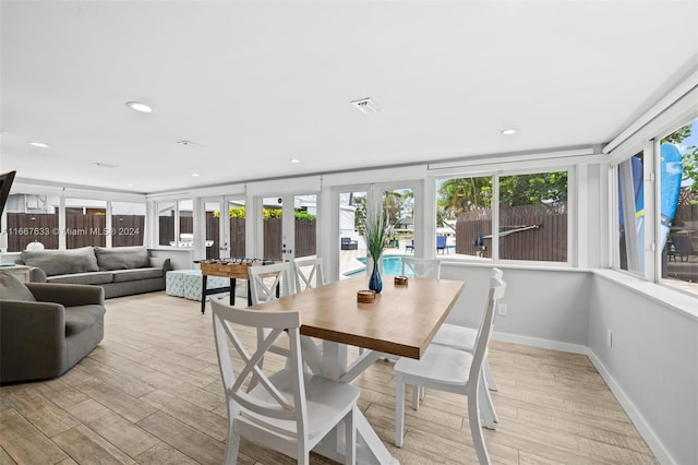 dining area featuring light hardwood / wood-style flooring and french doors