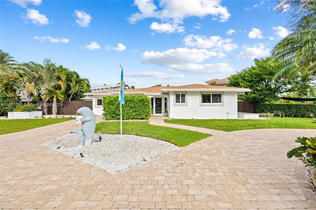 ranch-style home with a front yard