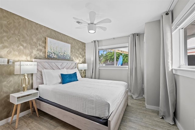 bedroom with ceiling fan and hardwood / wood-style flooring