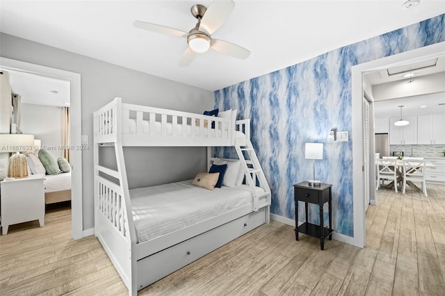 bedroom featuring light wood-type flooring and ceiling fan