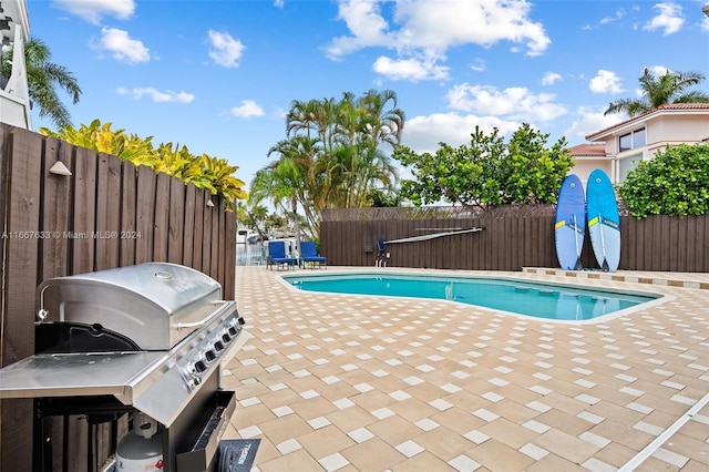 view of pool with a patio and grilling area