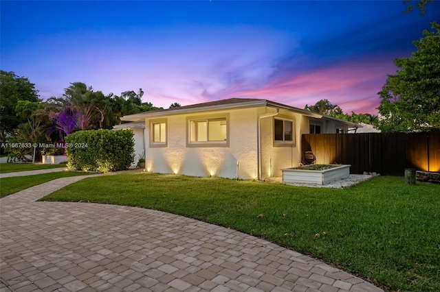 view of front of property featuring a patio and a yard