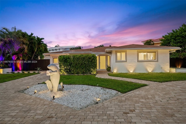 view of front of property with a lawn