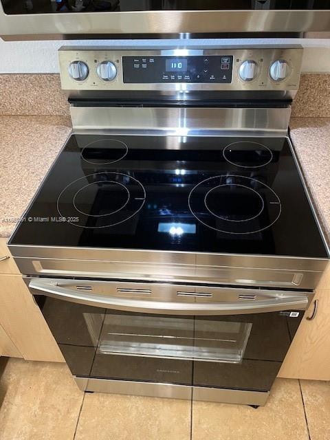 room details with light countertops and stainless steel range with electric cooktop