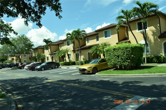 view of street with traffic signs, curbs, and a residential view