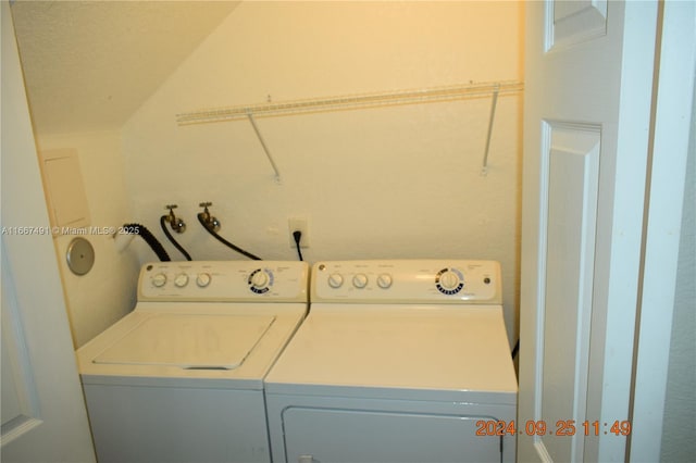 clothes washing area featuring washer and dryer and laundry area