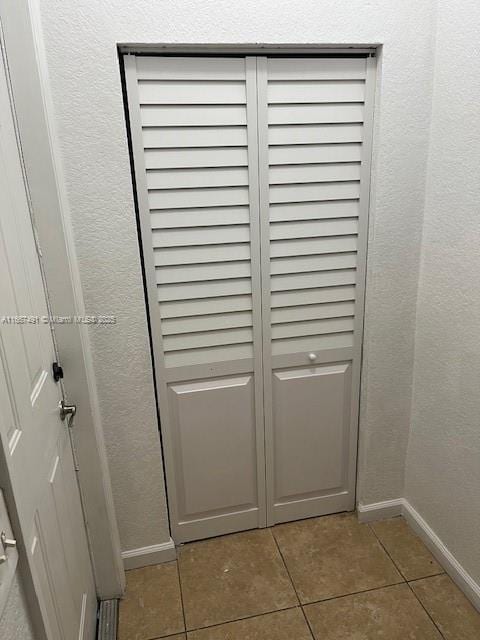 interior details with baseboards and a textured wall