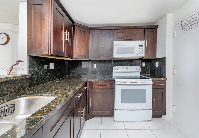 kitchen featuring white appliances, light tile patterned flooring, decorative backsplash, and dark stone counters